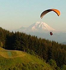 A paraglider launching from Tiger Mountain above Issaquah