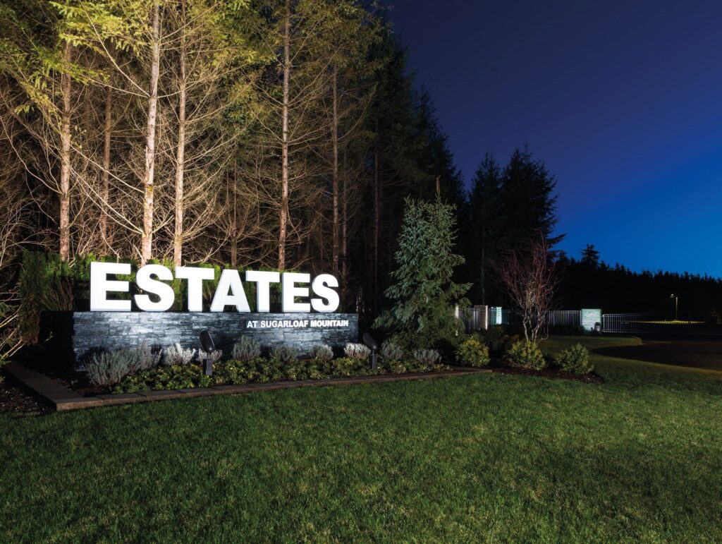 The lit entry sign for The Estates at Sugarloaf Mountain in Ravensdale, Washington