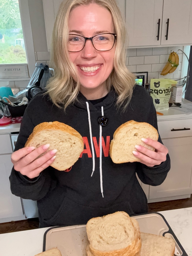 Tanya holding a fresh loaf of sourdough